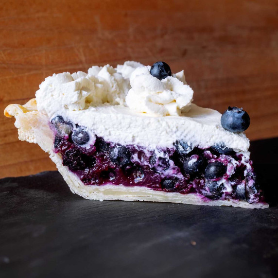 A slice of Publick House Blueberry Cream Pie on a counter.