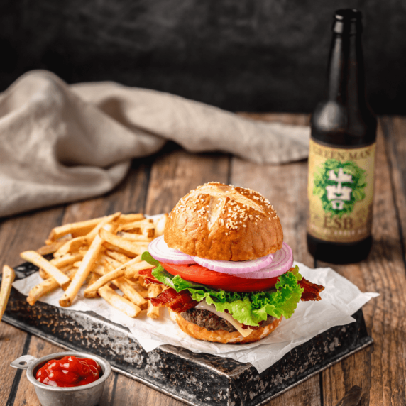 burger with homemade bun with fries and a beer