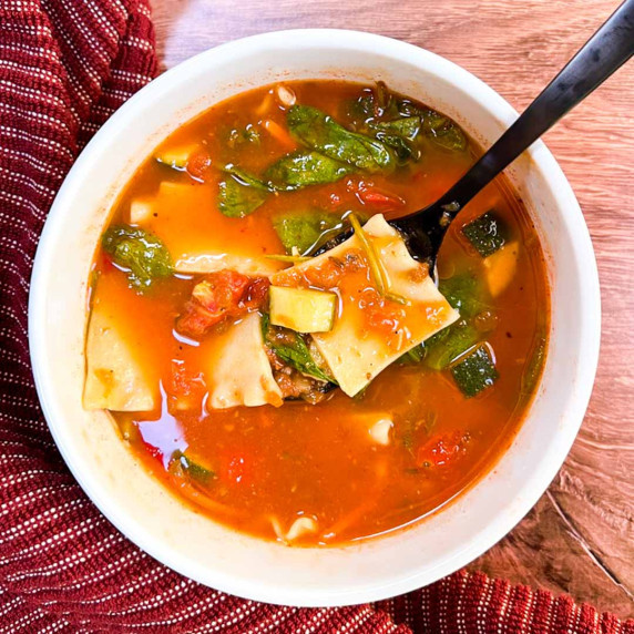 Spicy vegan lasagna soup in a white bowl.
