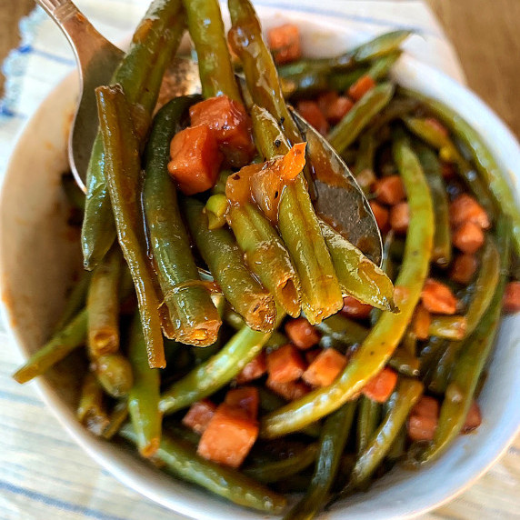  A spoonful of green beans and ham.
