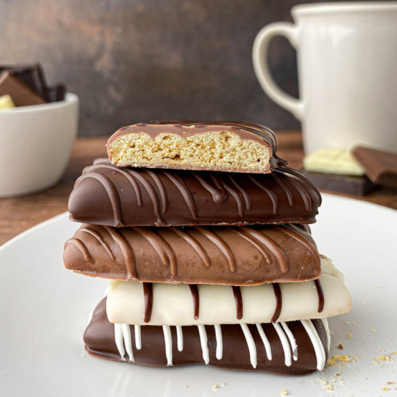 Stack of Chocolate Covered Graham Crackers on a white plate.