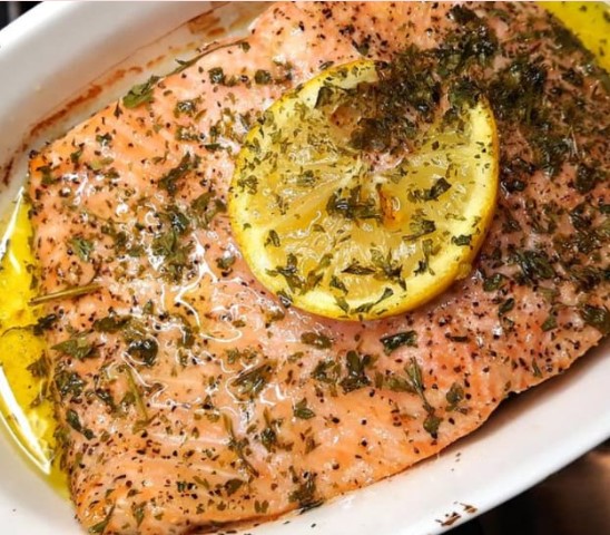 Trout fish placed in a plate with a lemon above
