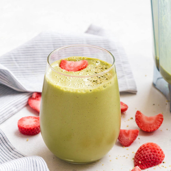 green smoothie made with strawberries and spinach