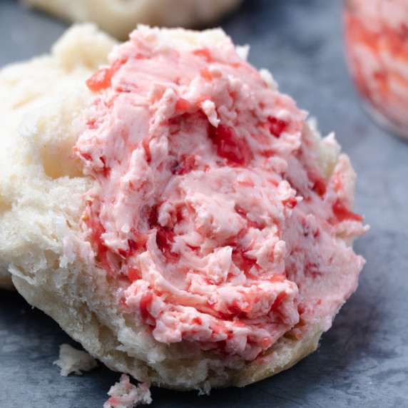 Strawberry butter slathered on a biscuit.