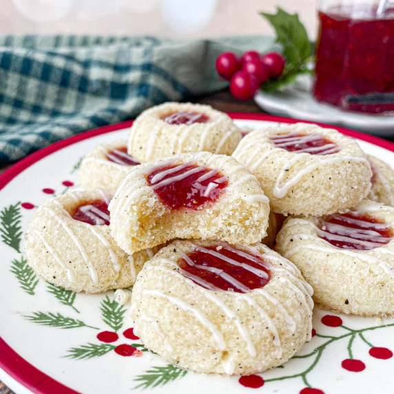 Stack of Strawberry Jam Cookies on a Christmas plate.