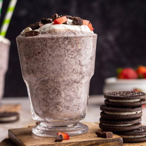 Strawberry Oreo milkshake in a glass with toppings