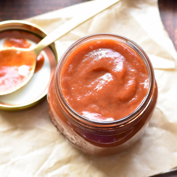 bbq sauce in a jar on parchment paper.