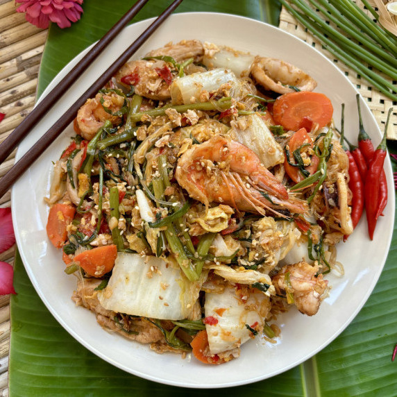 Thai sukiyaki stir-fry with chicken, shrimp, squid, and vegetables.