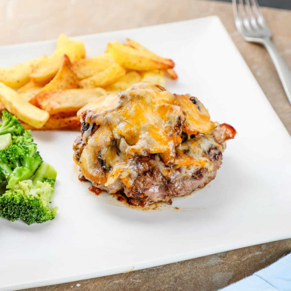 homemade texas roadhouse roadkill on a plate with steak fries and broccoli.