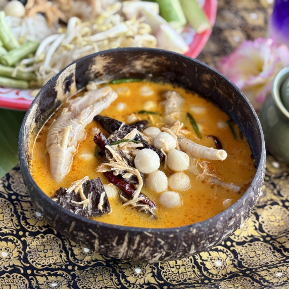 Authentic Thai chicken feet curry with red curry paste, creamy coconut milk, and vegetables.