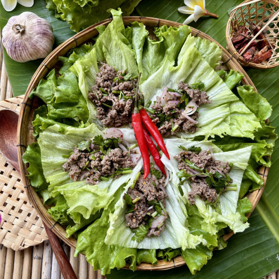 Thai ground beef lettuce wraps served on a bed of greens.
