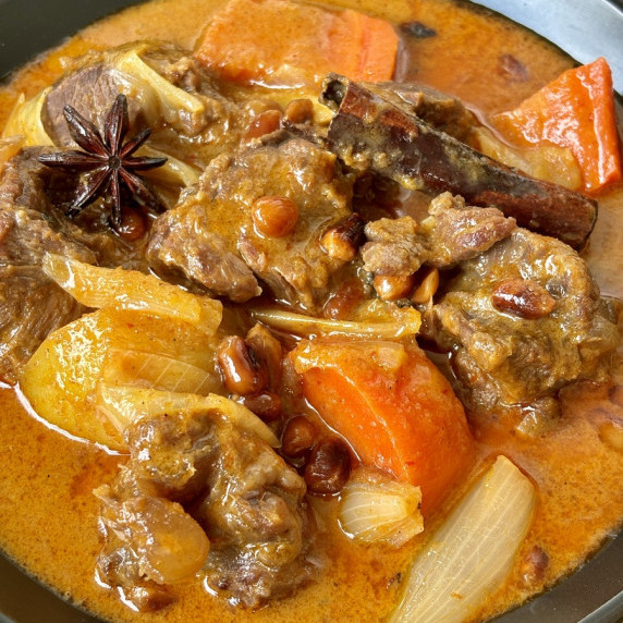 Close-up of gaeng massaman neua, Thai massaman beef curry, with potatoes and veggies.