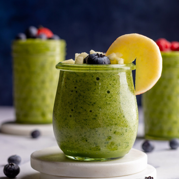 Green smoothie in a jar with fruit toppings