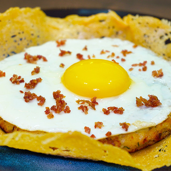 An egg on a cabbage mini pie plus a cheese basket.