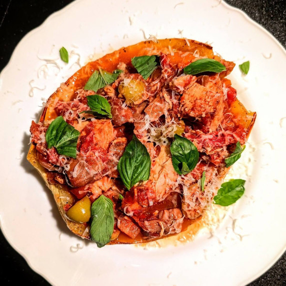turkey cacciatore with olives and tomatoes on a roasted spaghetti squash with basil and grated Parm