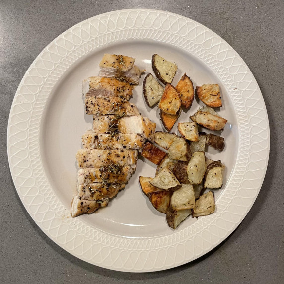 Chicken breast with a butter rosemary sauce and rosemary salted russet potatoes that are cubed.