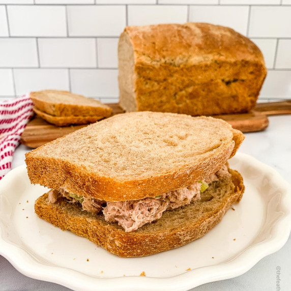 A plate of sandwich with whole wheat sourdough sandwich bread on a board